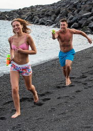 Couple go from playful to passionate on the beach